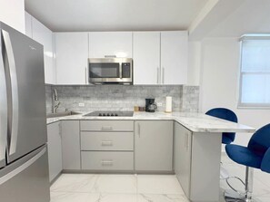 Fridge, microwave, stovetop, coffee/tea maker