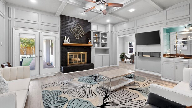 A modern living room with a fireplace, a ceiling fan, and a dining area. - Spacious 5-bedroom house in wonderful Richardson with Arcade Games (Richardson)