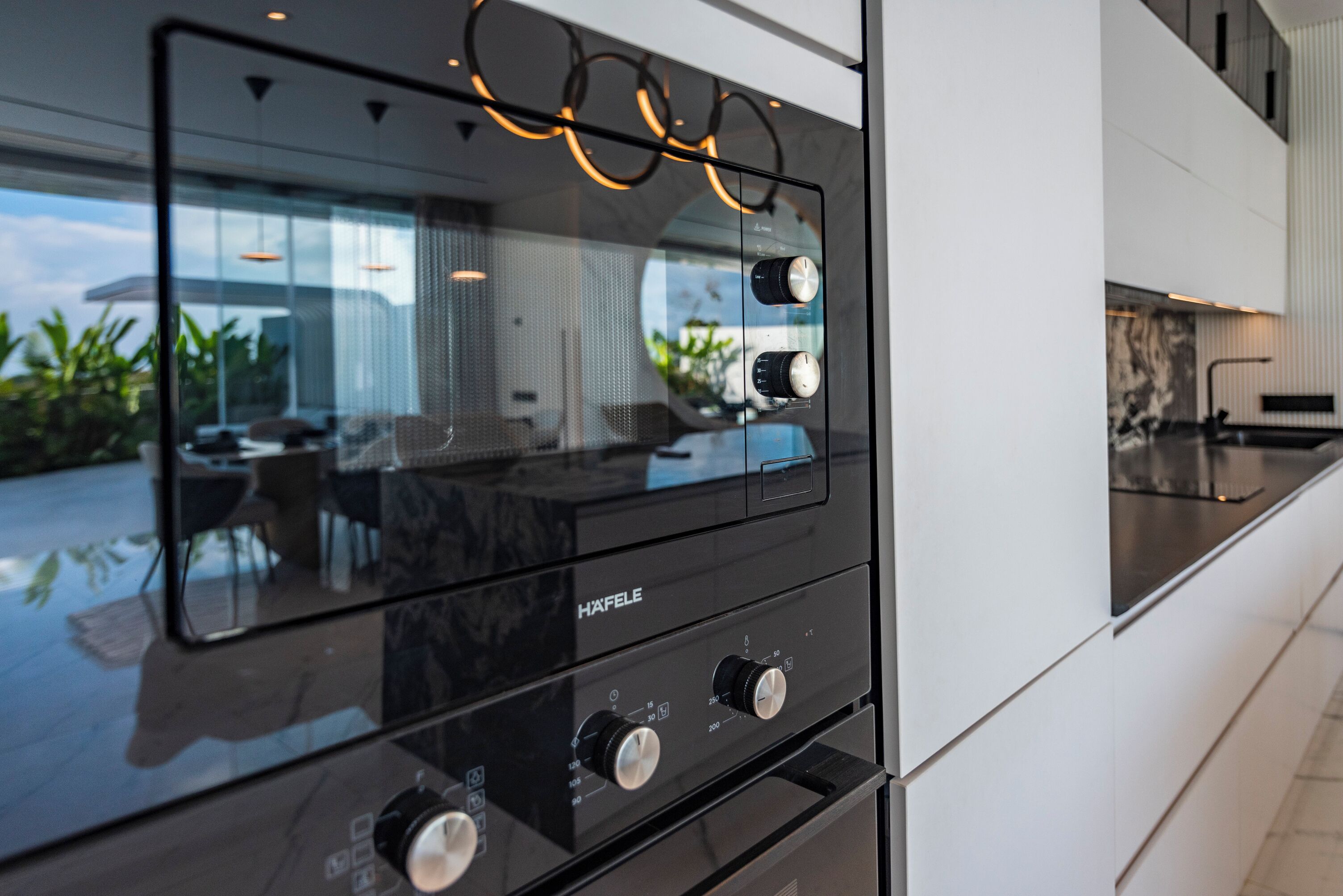 A modern kitchen with a sleek black stove and stainless steel appliances.