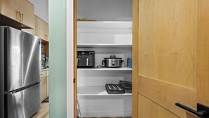 A compact kitchen with a built-in refrigerator, a microwave, and a stove. - Cozy 2 Bedroom Apartment within walking distance from the Hospital. (Williston)
