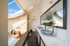 Separate tub and shower, free toiletries, hair dryer, slippers