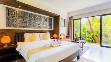 A well-lit bedroom with a large bed, a wooden headboard, and a wall art piece above the bed.