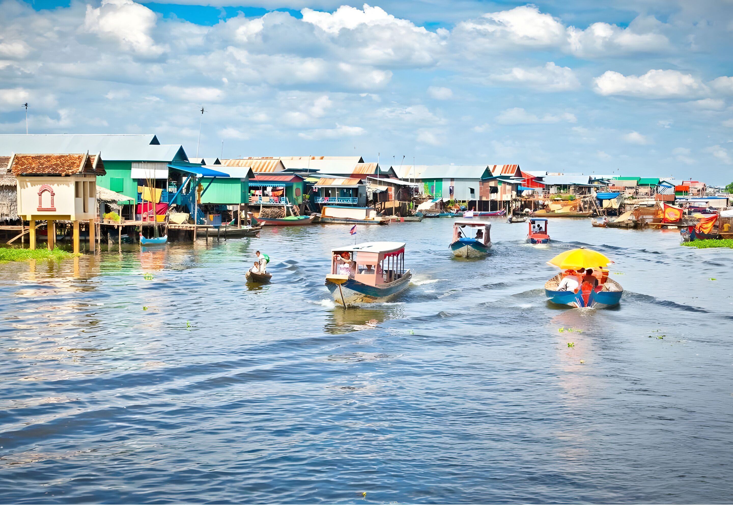 A waterway with boats and floating houses.