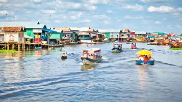 A waterway with boats and floating houses.