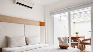 A hotel room with a bed, a window, and a view of the outside. - Exclusive Home in Private Club | Terrace, Pool, BBQ, A/C & 24/7 Security (Salinas)