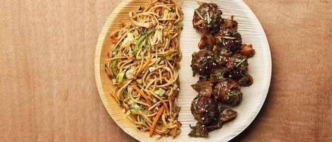 A plate with noodles and stir-fried vegetables.