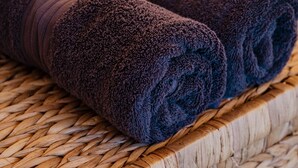 Two rolled towels on a woven mat. - Romantic Queen Bed Glamping Tent (Tomerong)