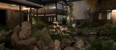 A traditional Japanese-style building with a koi pond and rock garden.