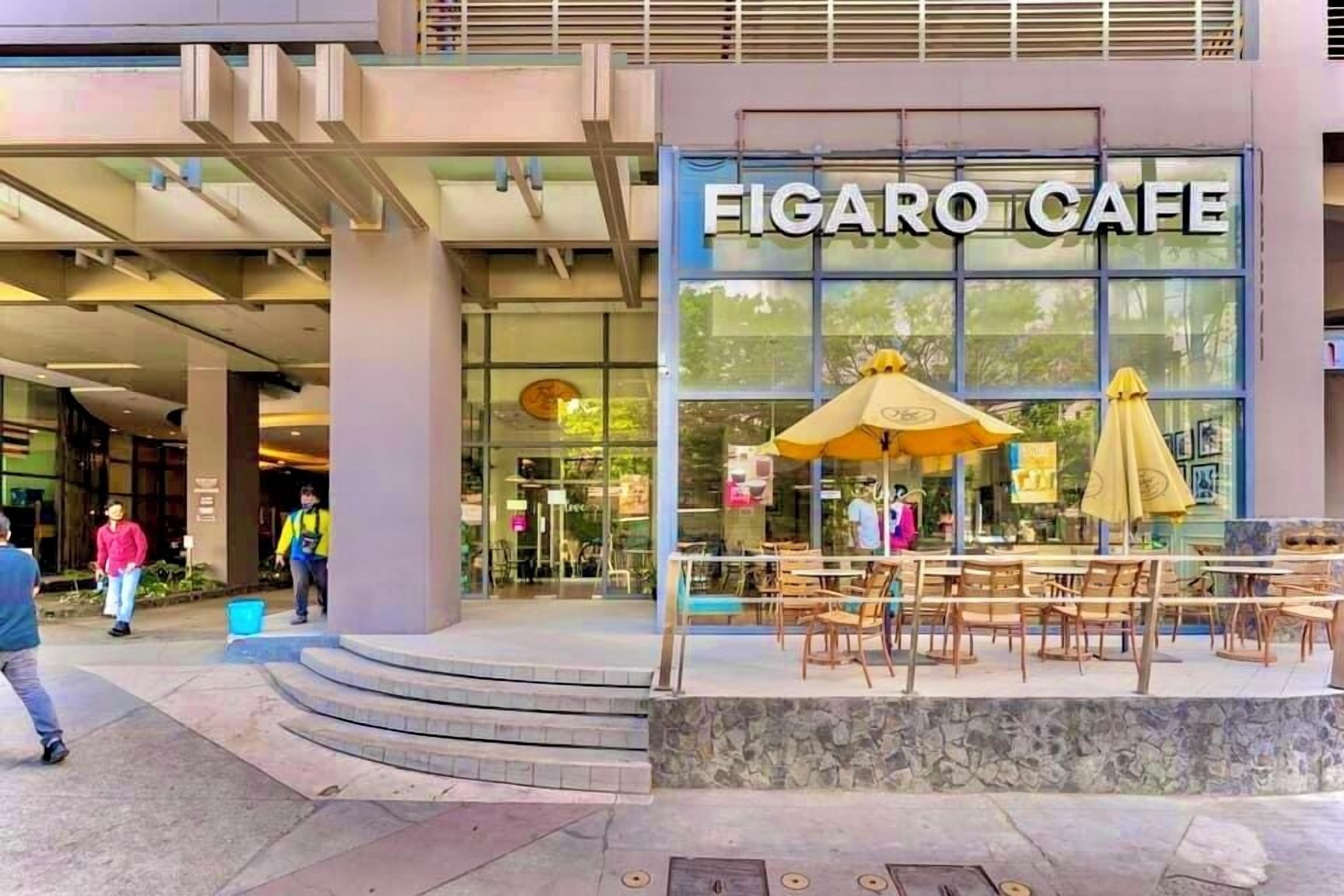 A Figaro Cafe with outdoor seating and a stone facade.