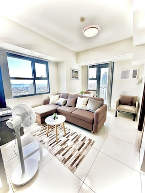 Deluxe Condo, Balcony, City View | Living area