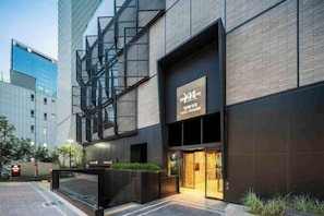 A modern building with a prominent entrance and a sign that reads 'M+M'. - Mercure Ambassador Seoul Hongdae (Seoul)