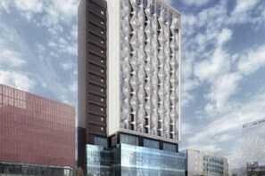 A modern high-rise building with a unique facade featuring a repeating geometric pattern. - Mercure Ambassador Seoul Hongdae (Seoul)