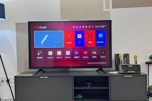 A television displaying a cloud interface with various app icons. - Senai 14pax The Joyous Home Pooltable Airport JPO (Senai)