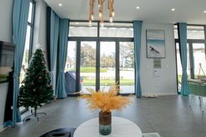 Deluxe Villa, 2 Bedrooms, Ocean View, Beachfront | Living area | 55-inch LED TV with cable channels