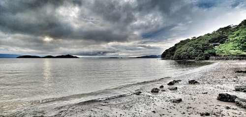 Teak House in a Forest Above the Beach