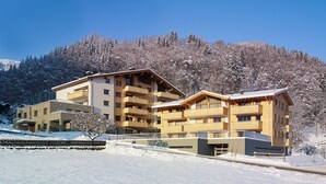 A multi-story hotel with balconies and a ski slope in the background. - Verwall Apartment 3 (Tschagguns)