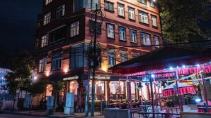 A multi-story hotel with illuminated signage and a rooftop deck. - Evara Boutique Hotel (Kathmandu)