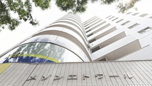 A modern building with a curved facade, multiple balconies, and a tiled ground floor. - Mezon Etowaru #706 (Nagoya)