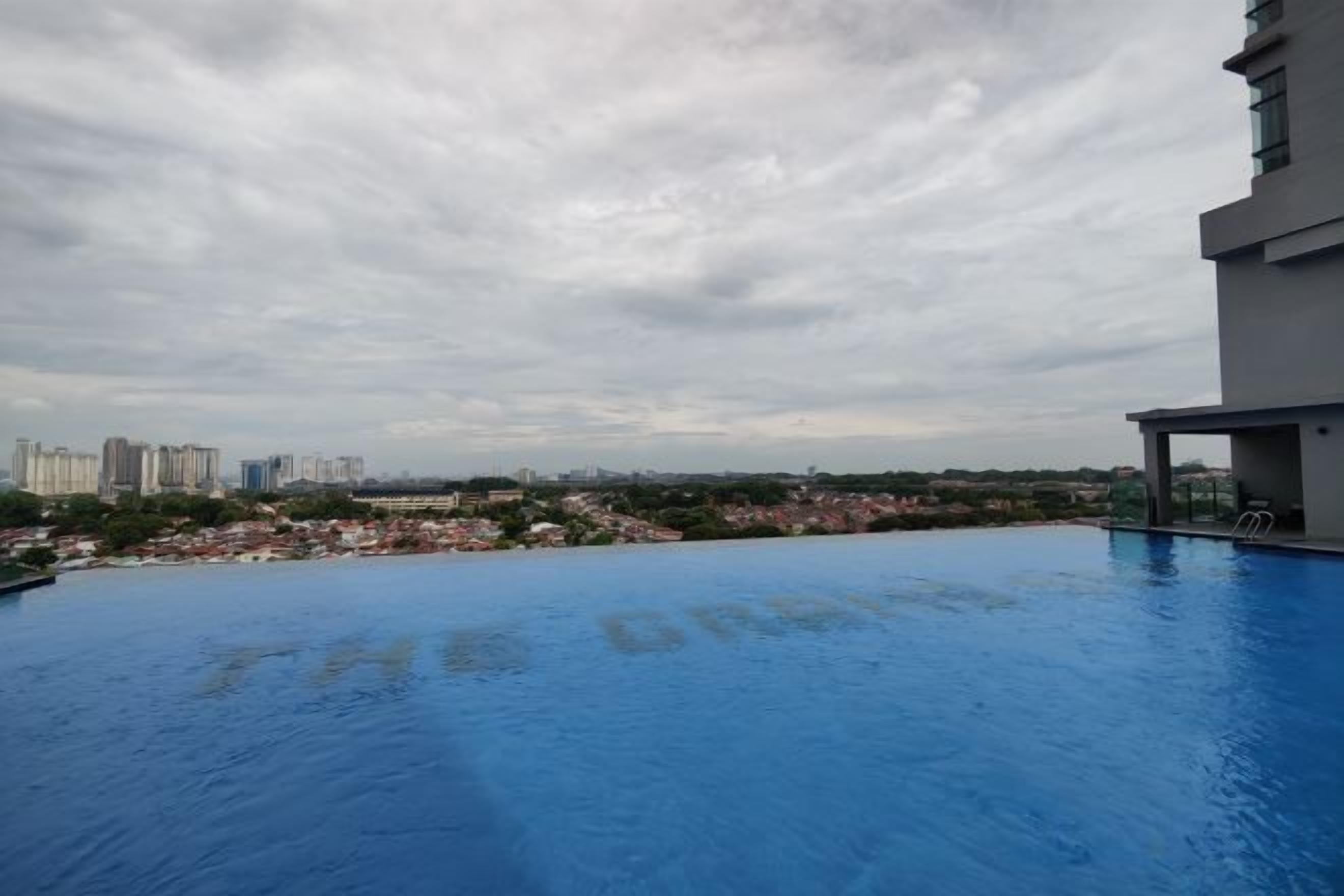 A rooftop pool with a view of a cityscape.