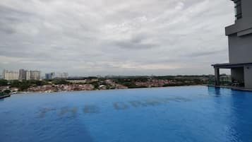 A rooftop pool with a view of a cityscape.
