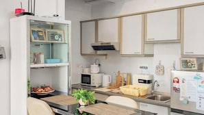A modern kitchen with white cabinets, a built-in microwave, a coffee machine, and a refrigerator with a digital display. - 1 Bedroom Apartment with balcony city view, Melaka Town Centre CBD (Melaka)