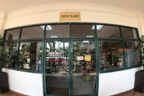 A Mini Mart store with a glass front and a sign indicating it is open daily. - 1 Bedroom Apartment with balcony city view, Melaka Town Centre CBD (Melaka)