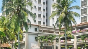 A multi-story hotel with balconies, palm trees, and a well-maintained garden. - 1 Bedroom Apartment with balcony city view, Melaka Town Centre CBD (Melaka)