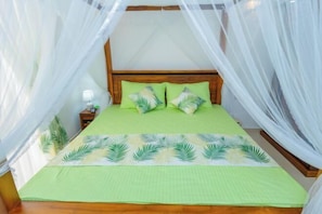 A bed with a canopy, a nightstand, and a lamp. - The Hideout - 2Br Villa Near Kahathuduwa Interchange (Polgasowita)