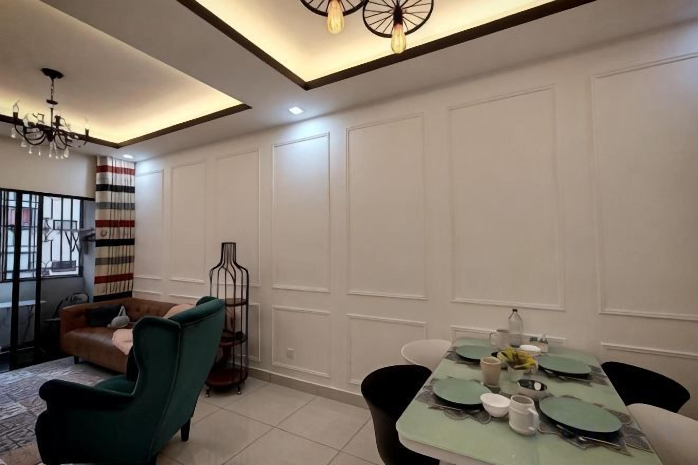 A dining area with a table set for four, a sofa, and a decorative chair.