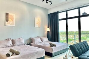 A hotel room with two beds, a sofa, a large window with a view, and wall art. - Emgrace/Near AeonTebrau/ IKEA Toppen /MountAustin (Johor Bahru)