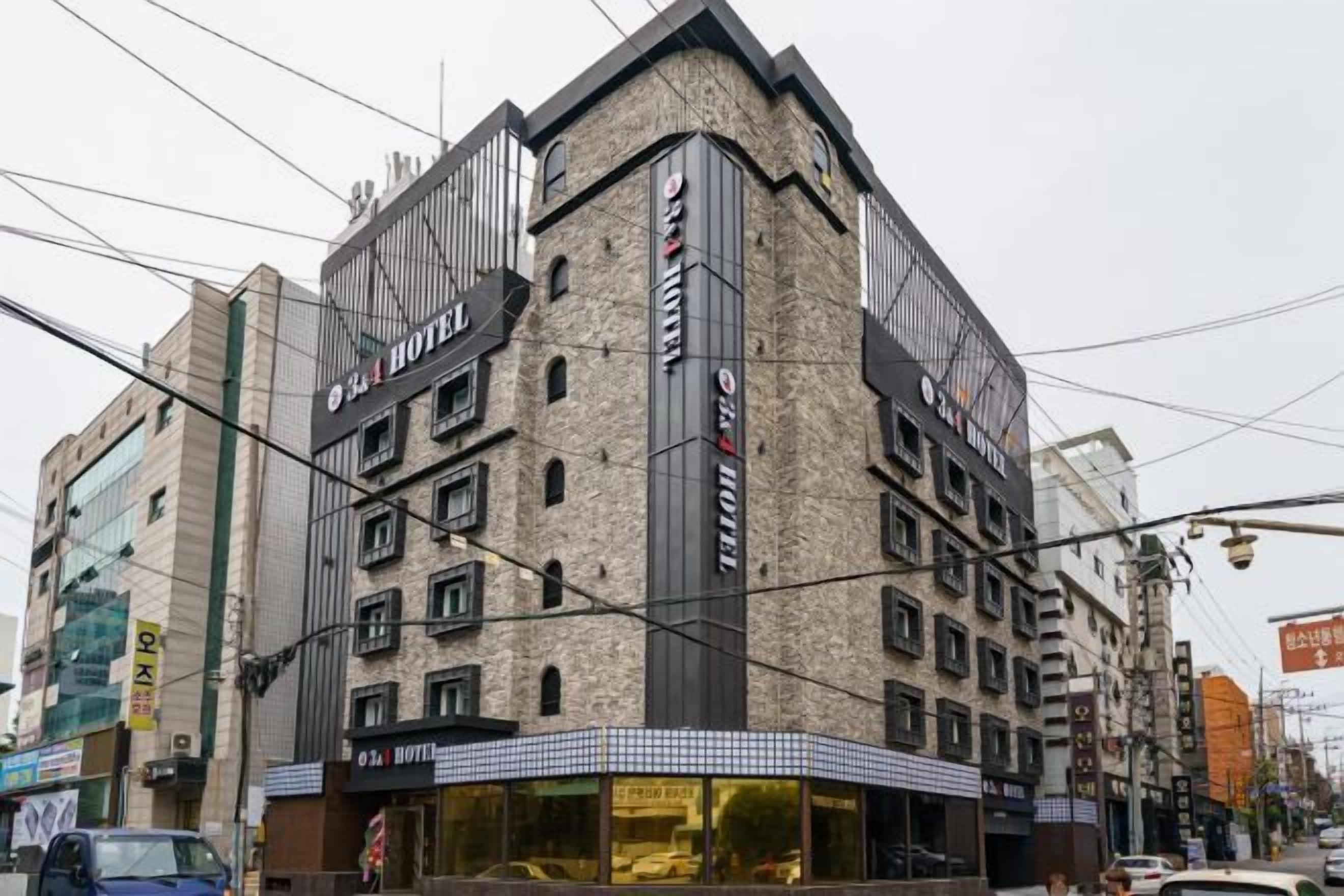 A multi-story hotel with a modern design, featuring a prominent sign and multiple windows.