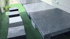 A patio area with a long, rectangular stone table and a series of steps leading up to it. - My Own House SURAT THANI (Surat Thani)