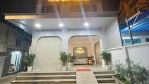 The entrance of Phú Gia Hotel with a closed garage door, potted plants, and a reception desk. - Phu Gia 2307 Huynh Tan Phat (Ho Chi Minh City)