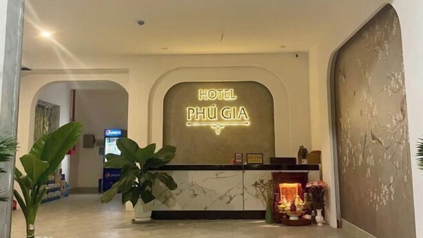 A hotel reception area with a neon sign reading "HOTEL PHÚ GIÁ". - Phu Gia 2307 Huynh Tan Phat (Ho Chi Minh City)