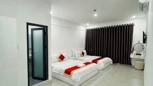 A hotel room with two beds, a bathroom, and a sliding glass door. - Phu Gia 2307 Huynh Tan Phat (Ho Chi Minh City)