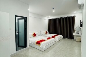 A hotel room with two beds, a bathroom, and a sliding glass door. - Phu Gia 2307 Huynh Tan Phat (Ho Chi Minh City)