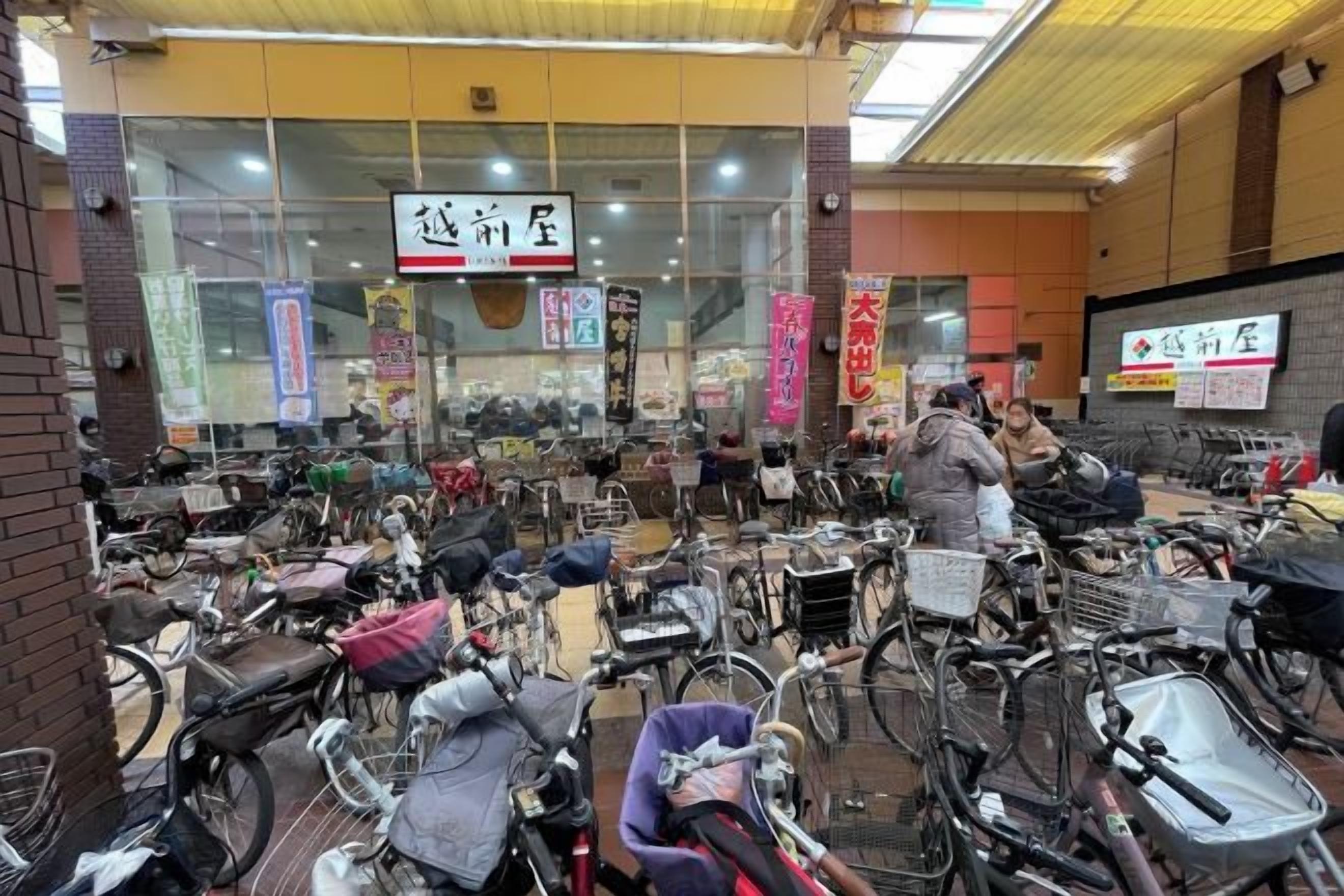 A bicycle rental shop with numerous bicycles and baskets.