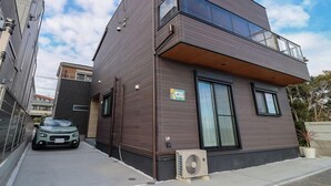 A modern two-story building with a flat roof, large windows, and a balcony. - Le Grand Bleu Resort Nagasawa (Yokosuka)