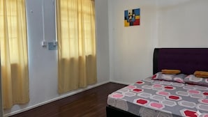 A bedroom with a bed, curtains, a wall art piece, and a window. - Ayana Homestay (Labuan)