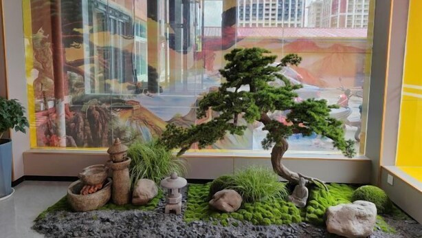 A traditional Japanese garden with a bonsai tree, rocks, and a stone lantern. - Ming Hua International Hotel (Boten)