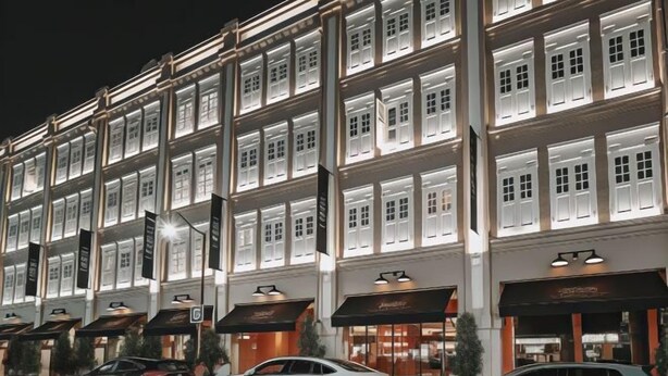 A multi-story hotel with illuminated windows and storefronts. - Hotel 1900 Express @ Chinatown (Short Overnight, 15 Hours, 6PM-9AM) (Singapore)