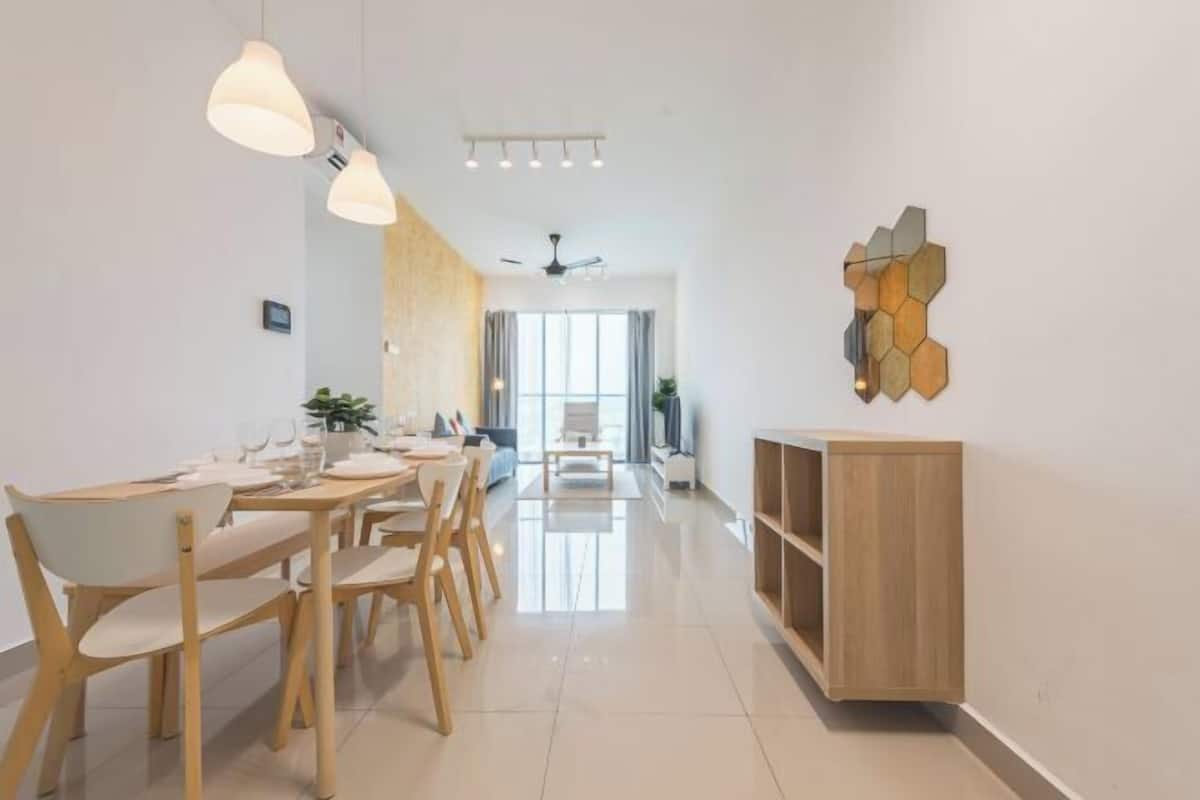 A modern dining area with a wooden table and chairs, a ceiling fan, and a wall-mounted hexagonal light fixture.