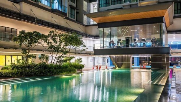 A multi-level indoor pool area with glass railings and a central water feature. - 2&3BR Family Suite Nr Sunway Velocity & LRT Maluri (Kuala Lumpur)