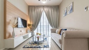 A modern living room with a sofa, TV, and a coffee table. - 2&3BR Family Suite Nr Sunway Velocity & LRT Maluri (Kuala Lumpur)