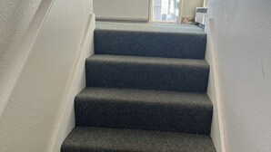 A staircase with carpeted steps leading to a door. - Nice 2-bedroom apartment in Anchorage (Anchorage)