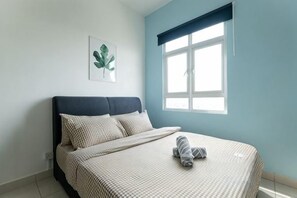 A bedroom with a bed, a window, and a wall-mounted plant. - TR Residence BY FEEL HOME (Kuala Lumpur)