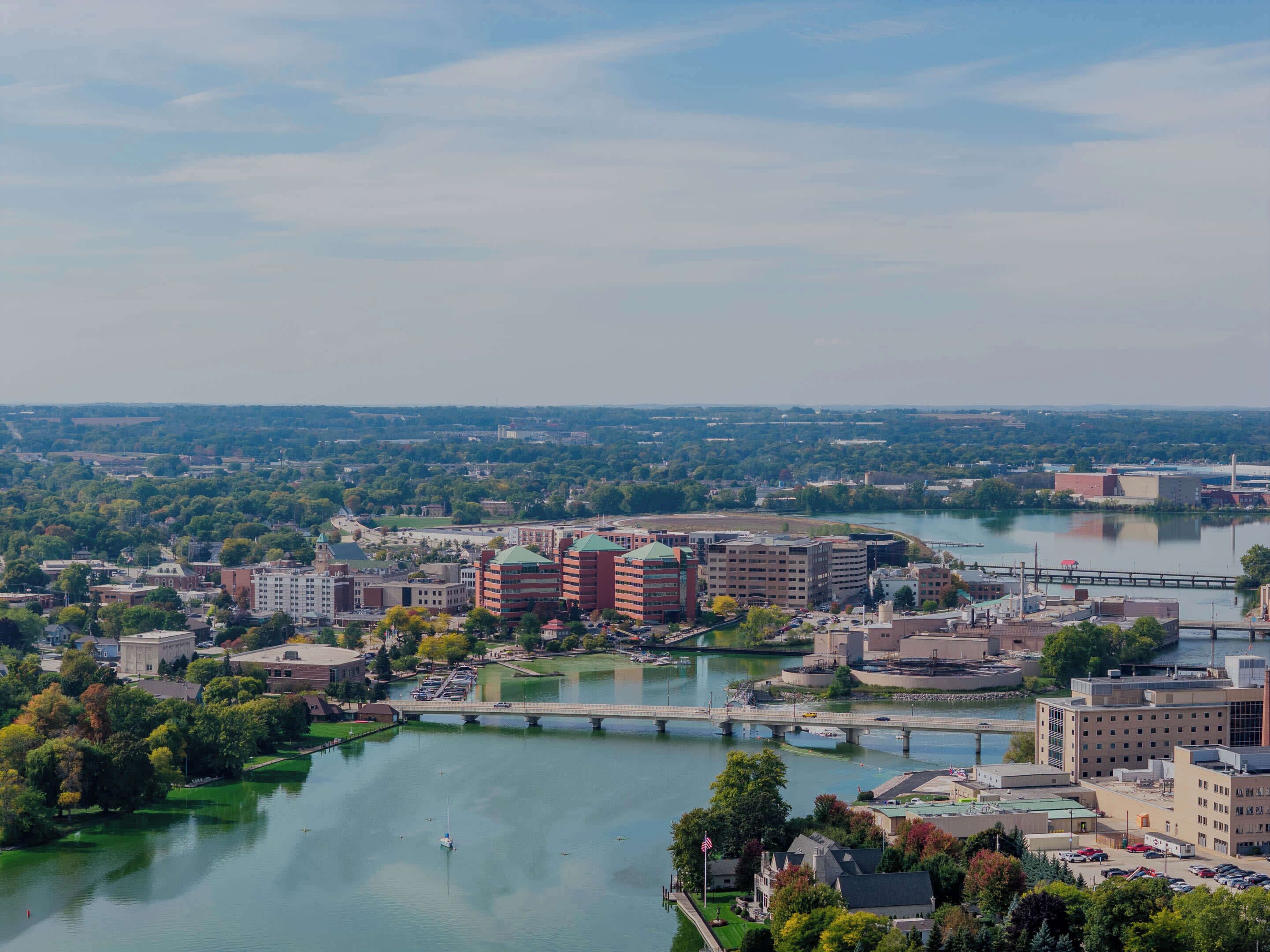 A cityscape with a river, bridges, and buildings.
