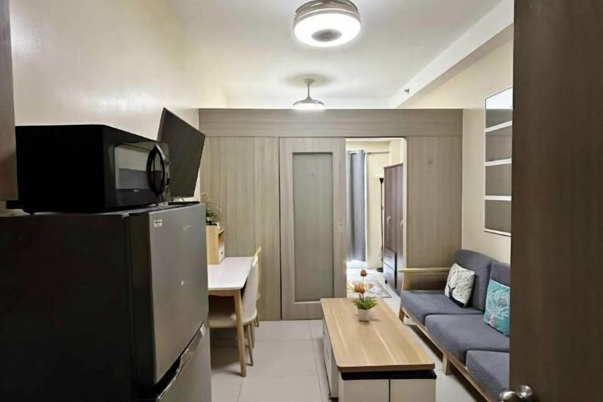 A compact living space with a kitchenette, a dining area, and a seating area.