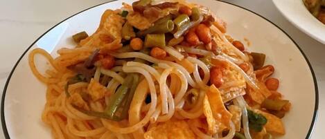 A plate of noodles with vegetables and tofu.
