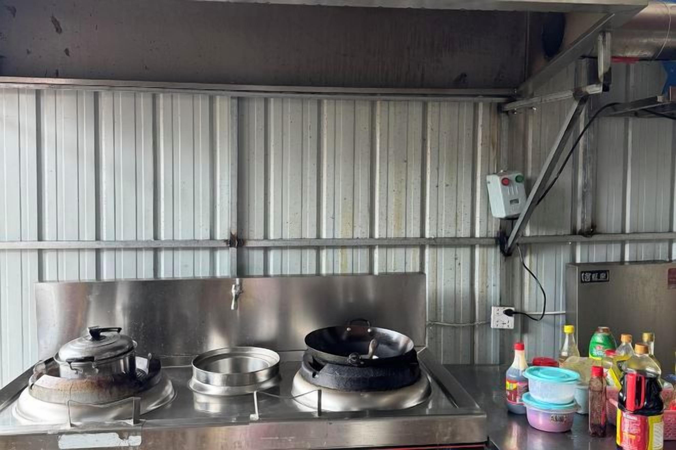 A kitchen with stainless steel appliances, including a stove and a sink.